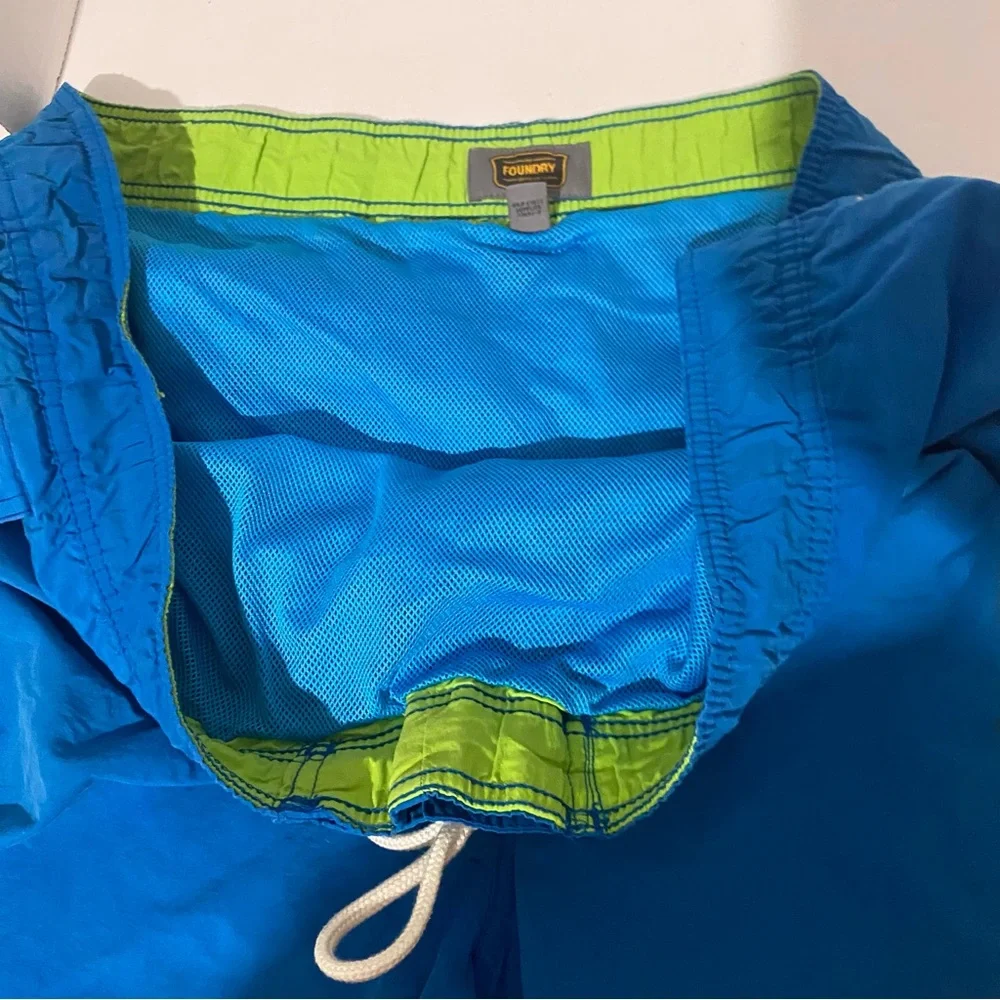 Men’s The Foundry Supply Co blue with green swim trunks. 3XL